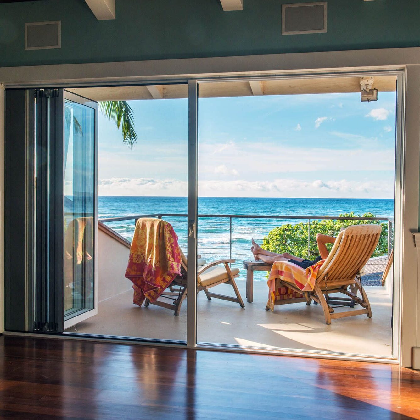 Relaxing beachfront view with lounge chairs and ocean horizon.